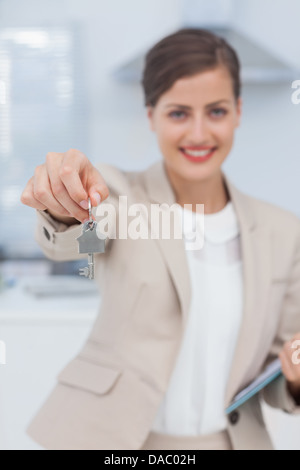 Hübsche Immobilienmakler bieten Hausschlüssel Stockfoto