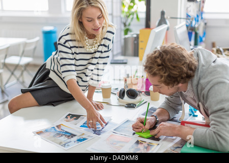 Junge Kolleginnen und Kollegen diskutieren Fotografien treffen in Kreativbüro Stockfoto