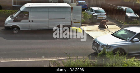 Preston, Lancs, UK. 12. Juli 2013. Teppich Monteure verlegen neue Teppich auf der öffentlichen Straße und Bürgersteig zu zwingen Autos drüber fahren zurechtgeschnitten. Bildnachweis: Sue Burton/Alamy Live-Nachrichten Stockfoto