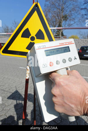Ein Geigerzähler ist vor einem Schild Warnung von Radioaktivität in Freiburg, Deutschland, 15. März 2011 statt. Foto: Patrick Seeger Stockfoto