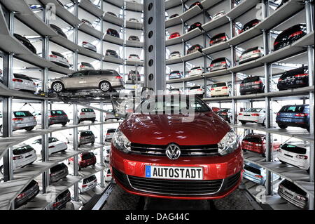 Ein VW Golf Cabrio und ein Passat Variant werden in einen freien Steckplatz in der Autotürme bei Volkswagen Autostadt in Wolfsburg, Deutschland, 9. März 2011 transportiert. Foto: Jochen Luebke Stockfoto