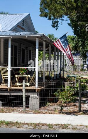 Amerikanische Sternenbanner Old Glory flag Wellen von breiten Veranda ein Cedar Key, Florida Bungalow. Stockfoto