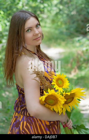 Portrait von hübschen grünen Augen Frau mit Sonnenblumen Stockfoto