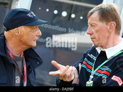 Das Bild zeigt frühere Rallye-Weltmeister, deutscher Walter Röhrl (R), im Gespräch mit ehemaligen Formula One Champion, Niki Lauda (L), im Fahrerlager der australischen Formel 1 Grand Prix auf dem Albert Park Circuit in Melbourne, Australien am 27. März 2011. Foto: Jens Büttner Stockfoto