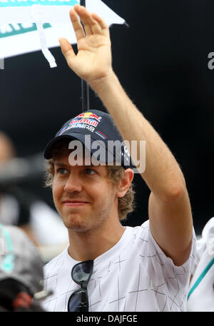 Deutsche Formel1-Fahrer Sebastian Vettel von Red Bull Wellen während des Fahrers Parade vor dem Formel 1 Grand Prix von Malaysia auf dem Sepang Circuit außerhalb Kuala Lumpur, Malaysia, 10. April 2011. Foto: Jens Buettner dpa Stockfoto