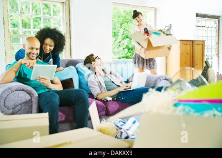 Freunde, die gemeinsam im neuen Zuhause entspannen Stockfoto