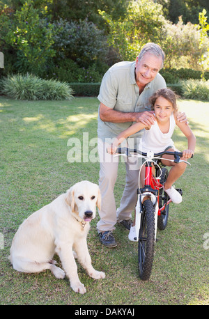 Älterer Mann mit Enkelin und Hund Stockfoto