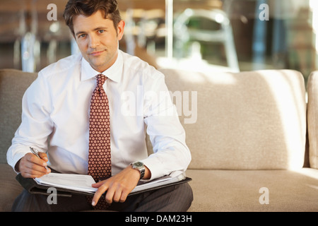 Geschäftsmann, Notizen auf sofa Stockfoto