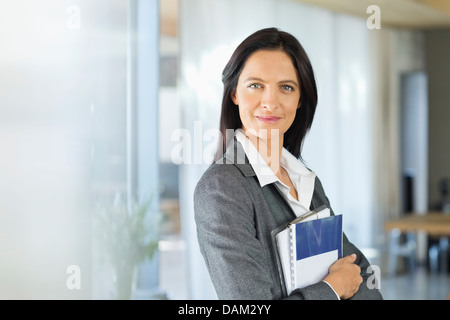 Geschäftsfrau, die lächelnd im Büro Stockfoto