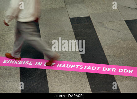 Ein Band mit dem Titel "Eintrag in die Hauptstadt der DDR" ist auf dem Boden der Bahnhof Friedrichstraße in Berlin, Deutschland, 5. August 2011 abgebildet. Die Marke ist Teil der Ausstellung "Der geteilte Bahnhof" anlässlich des 50. Jubiläums der Berliner Mauer. Die Ausstellung wird bis zum 15. August 2011 zu sehen sein und stellt Fotos und Dokumente des Bahnhofs. Foto Stockfoto