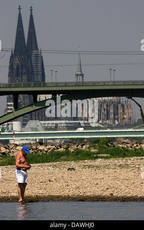 Ein Mann steht in der getrockneten, Rhein bei Köln, Deutschland, 27. April 2007. Die Lehre des Rheins bleibt gering aufgrund der anhaltenden Tiefgang. Das sommerliche Wetter bleibt mit Höhen bei 27 bis 31 Grad Celsius. Foto: Oliver Berg Stockfoto