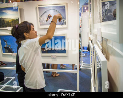 19. Juli 2013 Ausstellung in CentralWorld in Bangkok - Bangkok, Thailand - A Thai Frau nimmt ein Bild eines Fotos in ein Foto hängen. Die US-Botschaft in Bangkok sponserte die Fotoausstellung, die feiert 180 Jahre US-thailändische diplomatische Beziehungen. Es gibt 180 Fotos hängen in der Show, 90 von amerikanischen Fotografen in Thailand und 90 von Thai Fotografen in den Vereinigten Staaten. Die Show, die 19 Juli eröffnete hängt im CentralWorld, ein großes Einkaufszentrum in Bangkok, und tourt Thailand, wenn es seine Bangkok laufen am 21. Juli abgeschlossen. (Bild Kredit: Jack Kurtz/ZUMAPRESS.com ©) Stockfoto