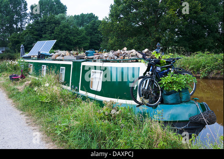 Schmale Boot mit Sonnenkollektoren vertäut am Trent und Mersey Kanal in der Nähe von Ritt Heide Cheshire England Vereinigtes Königreich UK Stockfoto