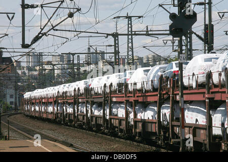 Ein Güterzug mit nagelneuen Autos im Bild, vorbei an der Station der Fulda, Deutschland, 1. August 2007. Foto: Uwe Zucchi Stockfoto