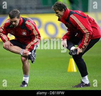 Mitglieder der deutschen Nationalmannschaft Lukas Podolski (L) und Torwart Jens Lehmann Strecken während der öffentlichen Team Praxis in Commerzbank-Arena in Frankfurt Main, Deutschland, 18. November 2007. Der Kader des deutschen Fußball Bund (DFB) bereitet sich auf seine Euro2008-Qualifikationsspiel gegen Wales am 21. November 2007. Foto: UWE ANSPACH Stockfoto