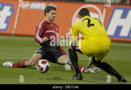 Griechischen Angelos Charisteas (L) des FC Nürnberg gleitet vorbei an Torhüter von AZ Alkmaar, Dutch Boy Waterman, während A UEFA Cup Gruppenspiel am Frankenstadium in Nürnberg, Deutschland, 5. Dezember 2007. Foto: Daniel Karmann Stockfoto