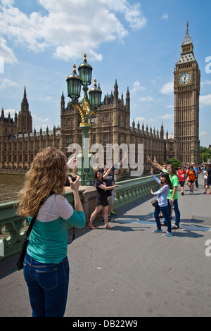 Touristen posieren für Fotos vor den Houses Of Parliament, London, England Stockfoto