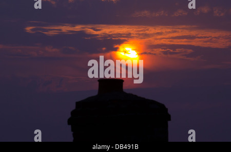 Silhouette des Hauses Schornsteine gegen Sonnenuntergang Stockfoto