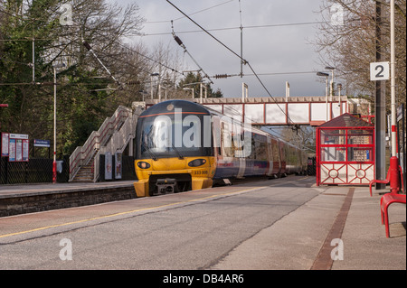 Northern Rail Zug (Motor cab & Trainer) nach oben ziehen, um verlassenen Bahnsteig an einem sonnigen Tag - Burley in Bösingen, West Yorkshire, England, UK. Stockfoto