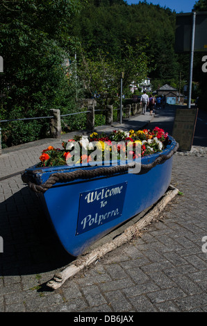 Blume-Display in einem Boot in der Fischerei Dorf Polperro, ein beliebtes Touristenziel an der südlichen Küste von Cornwall Stockfoto