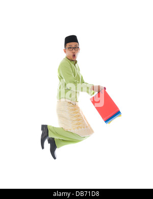 indonesische männlichen Einkaufs- und springen in Freude während Hari Raya Ramadan festival Stockfoto
