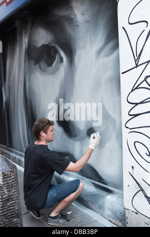 Graffiti-Künstler setzen Oberfläche berührt, um ein Wandbild. Stockfoto