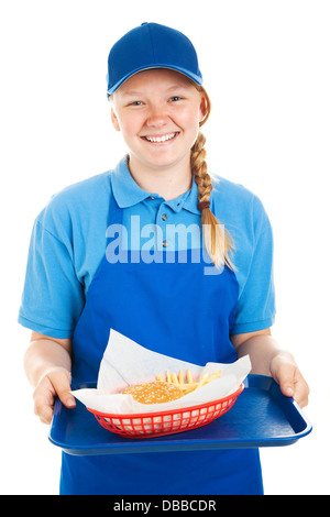 Teenager Fast-Food-Arbeiter einen Hamburger und Pommes frites serviert. Isoliert auf weiss. Stockfoto