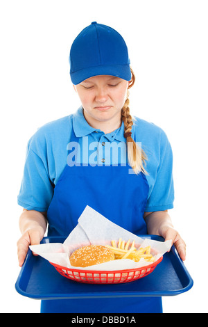 Teenager Arbeiter angewidert von einer Fast-Food-Burger und Pommes Frites. Isoliert auf weiss. Stockfoto
