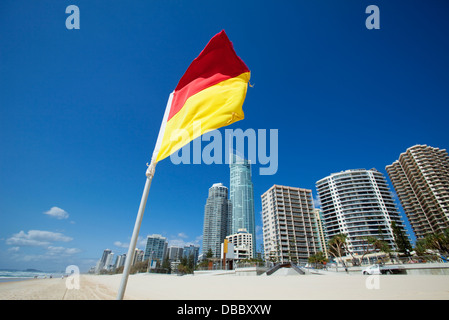Surf Lifesaving Fahne mit Skyline der Stadt im Hintergrund. Surfers Paradise, Gold Coast, Queensland, Australien Stockfoto
