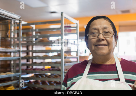 Hispanische Bäcker lächelnd in Küche Stockfoto