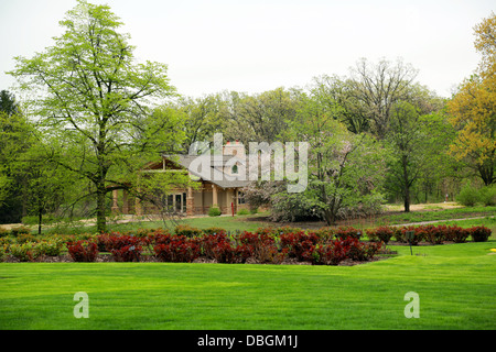 schönes Haus im Wald mit gepflegten Rasen Stockfoto