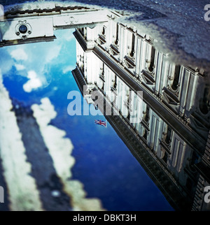 Reflexion des HM Treasury Gebäude in einer Pfütze mit einem Union Jack Flagge London England UK KATHY DEWITT Stockfoto