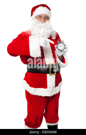 Santa zeigt auf eine antike Zeitmesser Stockfoto