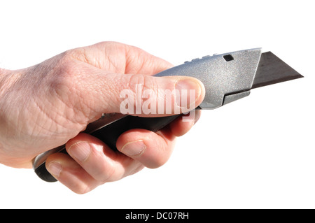 Männliche Hand, die ein Stanley-Messer / einen Boxschneider / ein Universalmesser hält Stockfoto