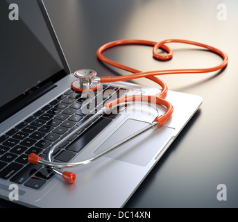 Laptop und Herz geformten Stethoskop auf dem Schreibtisch. Stockfoto