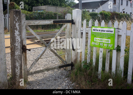 Ein Samariter melden Sie emotionale Unterstützung und Sicherheit für die Prüfung von Selbstmord bei einem unbemannten Bahnübergang in Reedham auf den Norfolk Broads. Isolierte Eisenbahnlinien wie dies im Vereinigten Königreich sind oft Orte wo die verzweifelte machen schwere Entscheidungen über ihr Leben und die Samariter ihre Anwesenheit bekannt machen indem man Schilder mit den dazugehörigen Telefonnummern als Abschreckung in dieser ländlichen Ecke der britischen East Anglia, bekannt für seine flachen Fenland Landschaft, weiten Himmel und kleinen Gemeinden genannt. Stockfoto