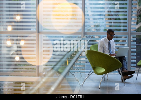 Geschäftsmann mit Laptop in der lobby Stockfoto