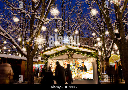 Schweiz, Basel. Münsterplatz Wintermarkt Urlaub. Weihnachtslicht in einer Winternacht auf dem Musterplatz-Markt. Stockfoto