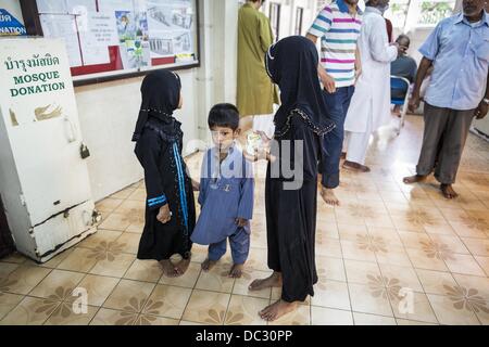 Bangkok, Thailand. 8. August 2013. Kinder warten auf ihren Vater vor dem Eid al-Fitr Dienste in den Eingangsbereich von Haroon Moschee in Bangkok. Eid al-Fitr ist '' Festival brechen des Fastens,'' es nennt auch die geringeren Eid. Es ist ein wichtiger religiöser Feiertag von Moslems weltweit gefeiert, der markiert das Ende des Ramadan, der islamische heilige Monat des Fastens. Die religiösen Eid ist ein Tag und Muslime sind nicht gestattet, an diesem Tag zu fasten. Bildnachweis: ZUMA Press, Inc./Alamy Live-Nachrichten Stockfoto