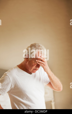 Ältere Mann hielt Kopf Schmerzen Stockfoto