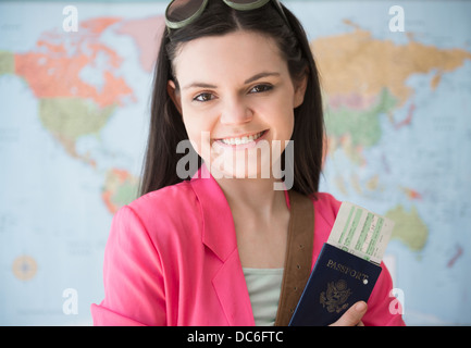Junge Frau stand vor der Karte und im Besitz Pass Stockfoto