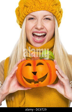 Junge Frau in Mütze und Schal mit Jack-o-Laterne Stockfoto