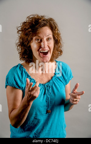Eine 50 Jahre alte Auburn dunkelhaarige Frau zeigt positive Begeisterung. Stockfoto