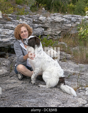 Eine Frau und ihr Hund teilen sich einen ruhigen Moment während des Urlaubs auf Washington Island, Wisconsin. Stockfoto