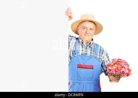 Reife Floristen halten einen Blumenstrauß und posiert auf eine Blindplatte Stockfoto