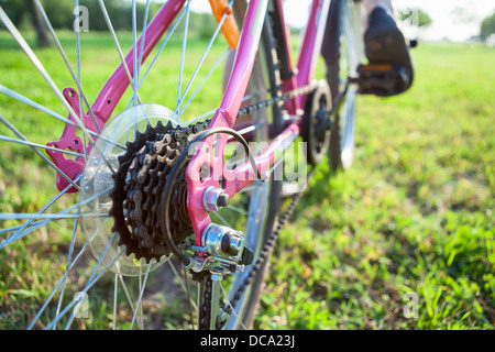 Detailansicht der Fahrrad Ritzel am Hinterrad des Fahrrads und Füße auf den Pedalen Stockfoto