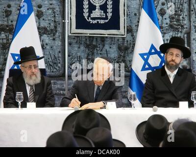 Jerusalem, Israel. 14. August 2013. President Shimon Peres (C) Zeichen der Einweihung Eide der Chief sephardische Rabbi YITZHAK YOSEF (L) und Chief Ashkenazi Rabbi DAVID LAU (R) an die offizielle Vereidigung der neuen Oberrabbiner Israels. Jerusalem, Israel. 14. August 2013.  Präsident des Staates Israel, Shimon Peres, beherbergt die offizielle Vereidigung der neuen Oberrabbiner Israels, Lau und Yosef, im Beisein von Justizministerin Tzipi Livni und stellvertretender religiösen Angelegenheiten Minister Ben-Dahan. Bildnachweis: Nir Alon/Alamy Live-Nachrichten Stockfoto