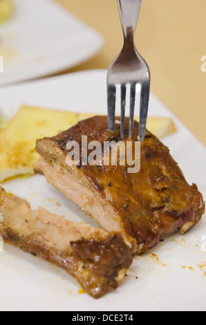 Gegrilltes Schweinefleisch Baby Back Ribs mit Gabel und Knoblauchbrot Stockfoto