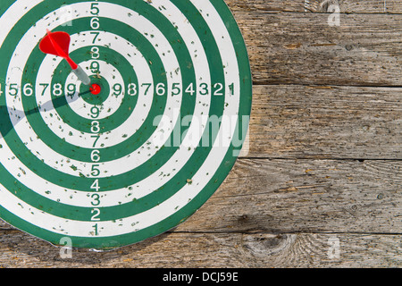 Roter Pfeil Treffer ins Schwarze des Dartboards Stockfoto