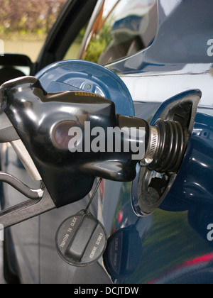 BENZIN PUMPE DÜSE PUMPEN GAS IN DUNKEL BLAU AUTO AN AMERIKANISCHEN TANKSTELLE Stockfoto